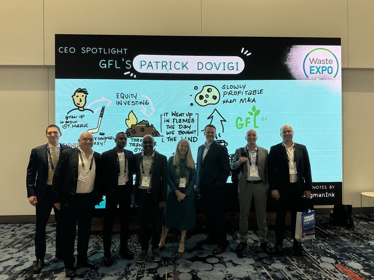 Group photo in front of the WasteExpo CEO Spotlight stage